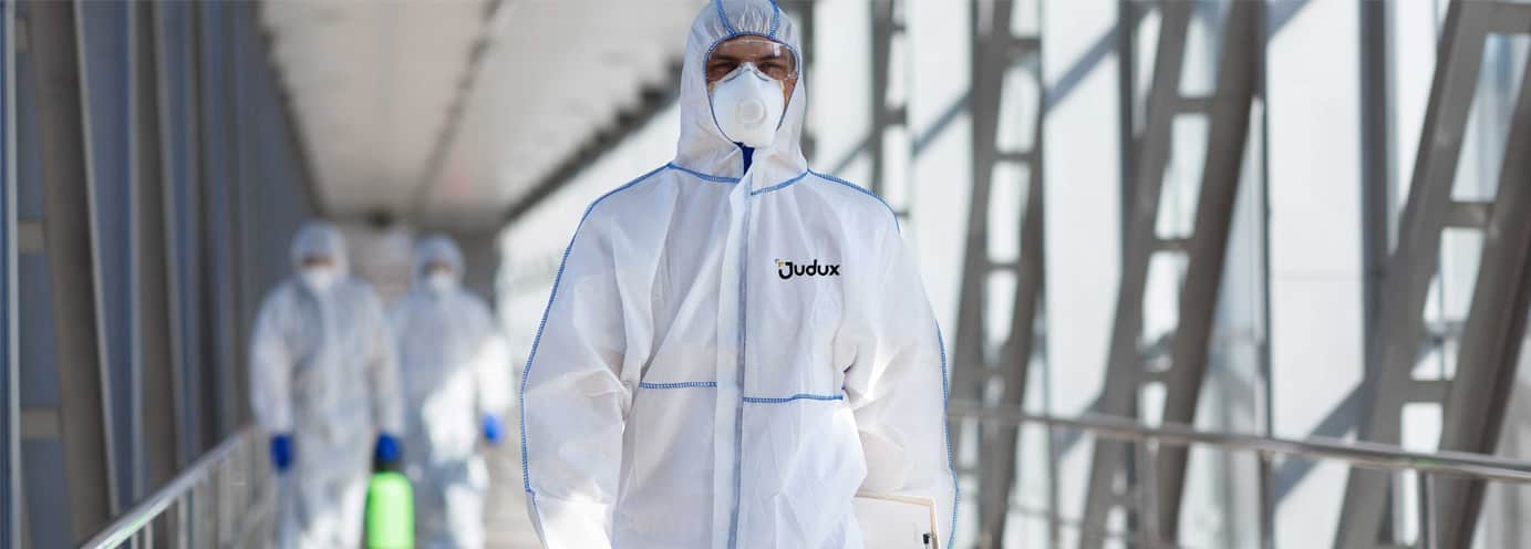 A team of disinfection professionals wearing protective suits and masks, ensuring a sanitized and safe environment